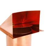 Inside view of hooded wall vent with screen and damper in copper.