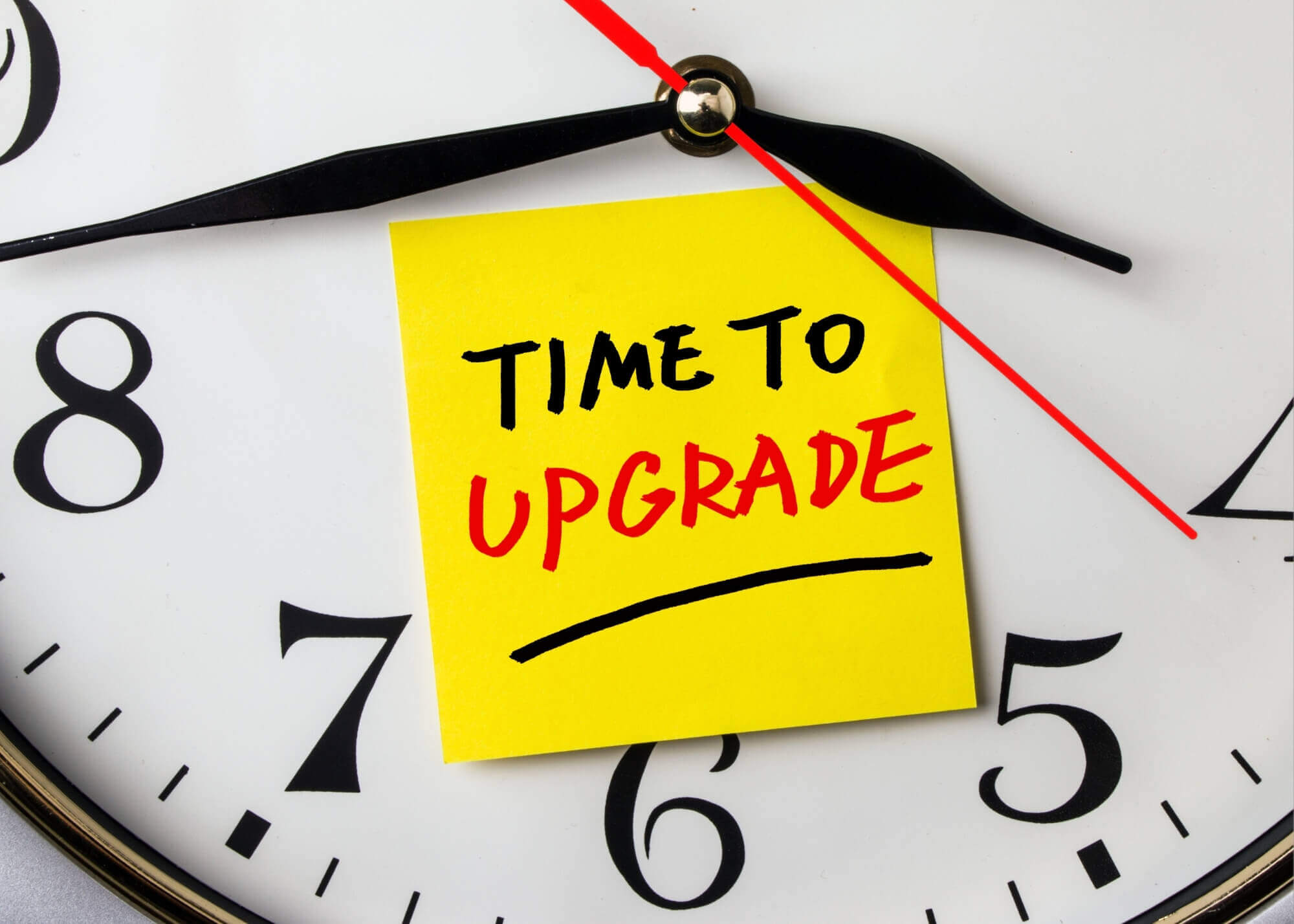 clock with time to upgrade sticky note on it