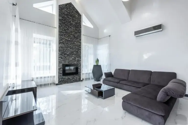This image depicts a living room with a mini-split air conditioning unit mounted to the wall.